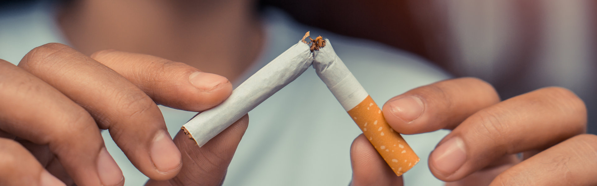 Cigarette.World No Tobacco Day Concept.Stop smoking cigarettes concept. Closeup woman holding broken cigarette in hands.